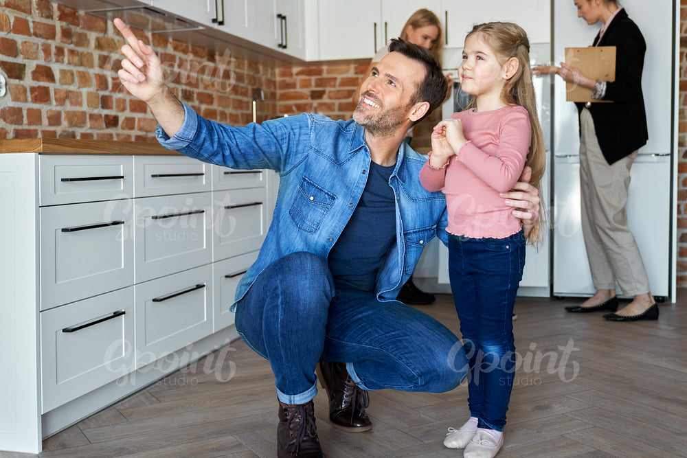 Happy family watching a new apartment before buying