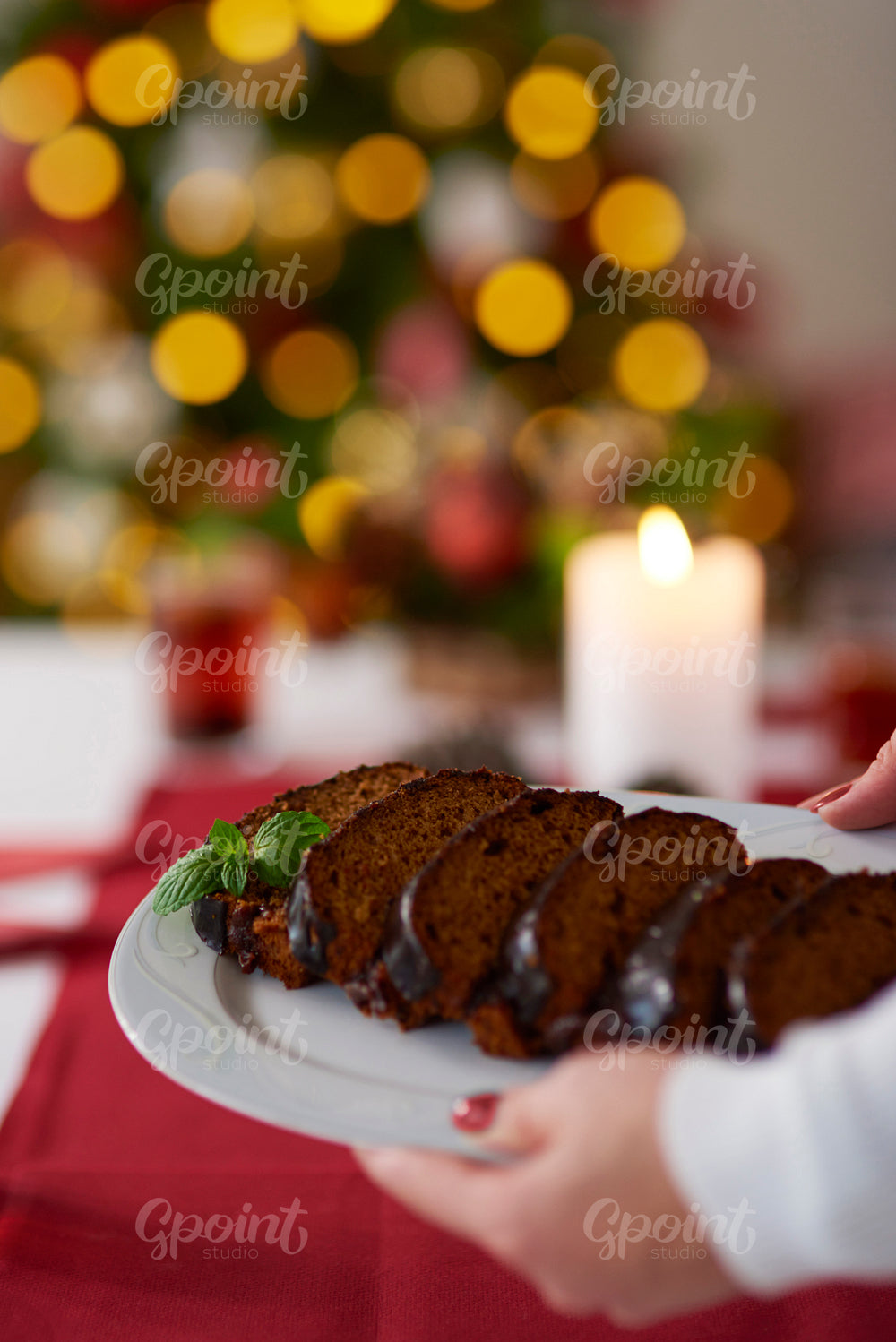 Woman bringing a plate with ginger bread