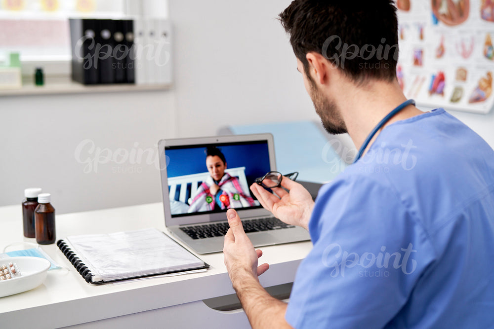 Rear view of doctor making an online consultation