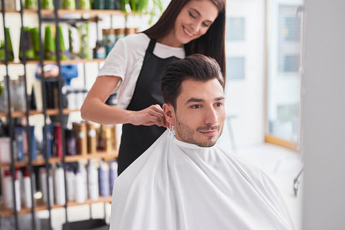 Hairstylist and male customer in hair salon