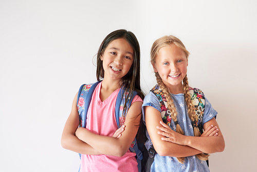 Portrait of two pretty girls with backpacks