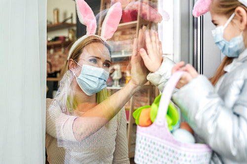 Mother greeting little daughter during the Easter quarantine