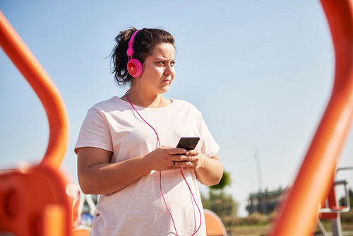 Woman choosing playlist for exercising