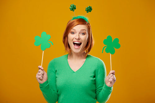Screaming woman holding clover shaped banner with copy space