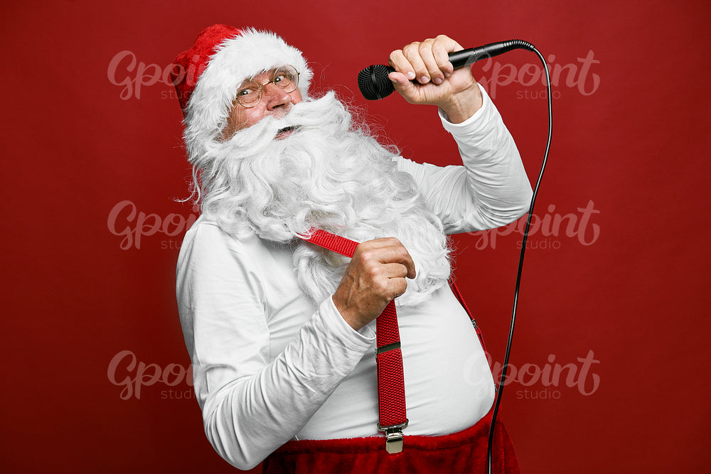 Caucasian Santa Claus singing with microphone 