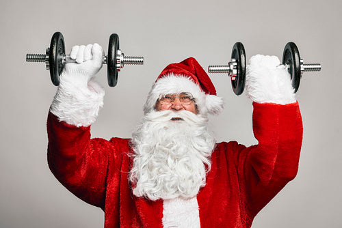 Santa Claus with large dumbbells