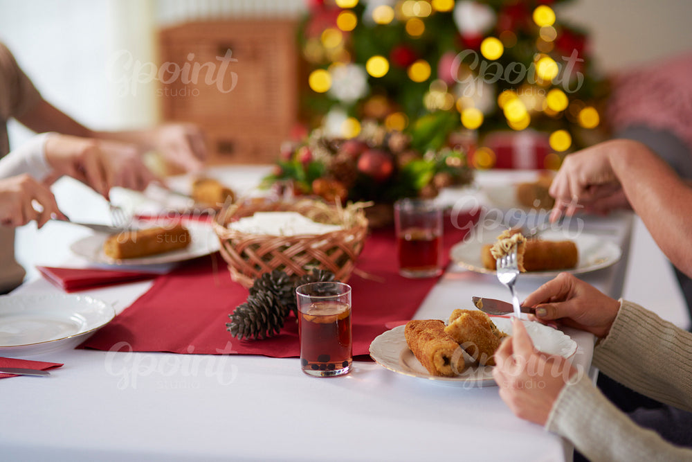 People eating croquette over Christmas table