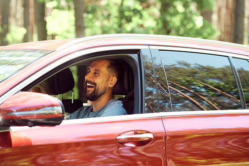 Happy man during trip driving by car