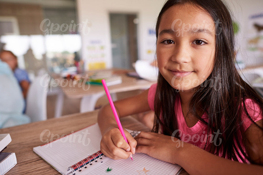 Asian girl creating in her notebook