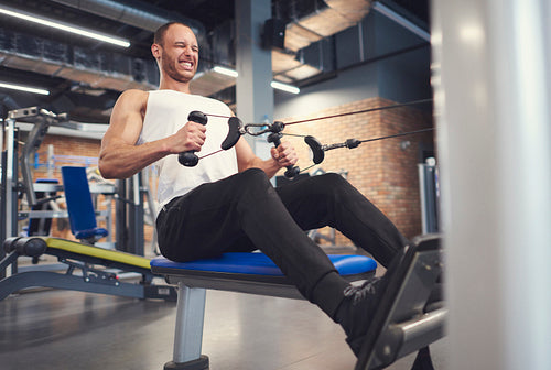 Male athlete working on rowing machine