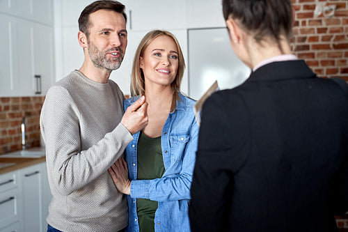 Couple talking to a real estate agent