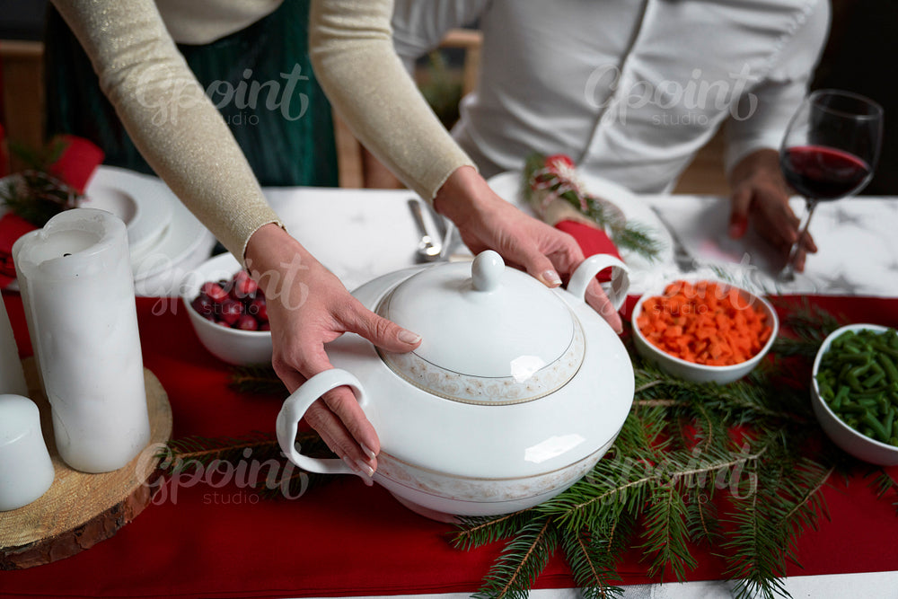 Woman serving meal on Christmas dinner