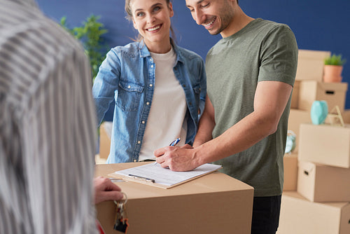 Couple signing a house purchase agreement