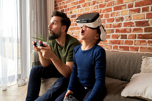 Father and son spending time together playing video game