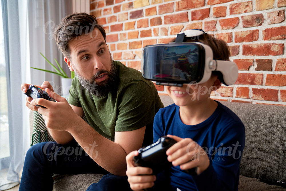 Surprised father playing video game with his son