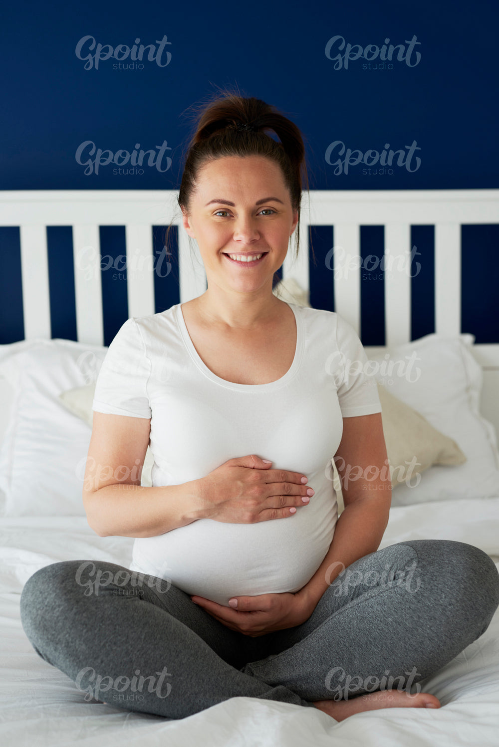Vertical portrait of pregnant woman in bed