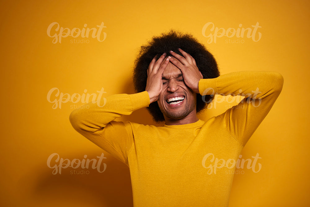 Excited man on yellow background