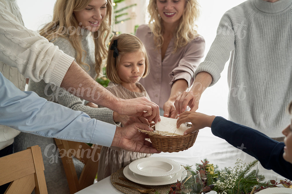 Caucasian family sharing wafer during the Christmas Eve