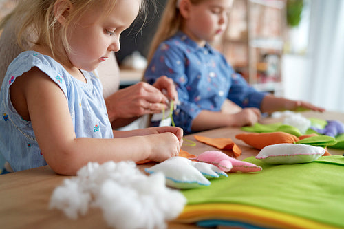 Close up of little girls making Easter toys