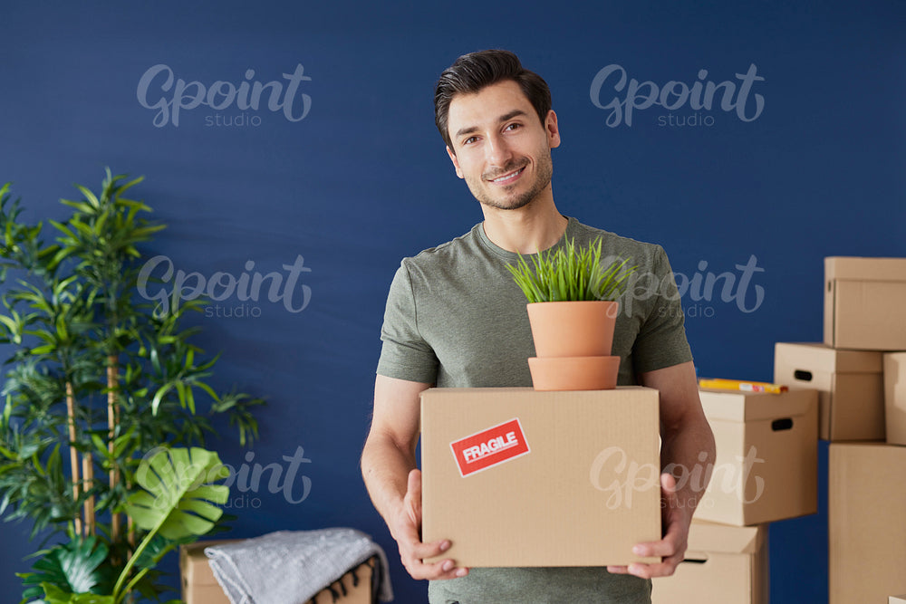 Portrait of young man with a cardboard box