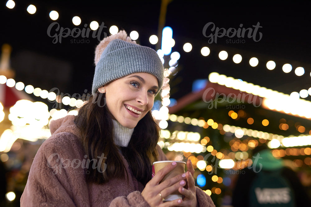 Close up of woman drinking mulled wine on cold night