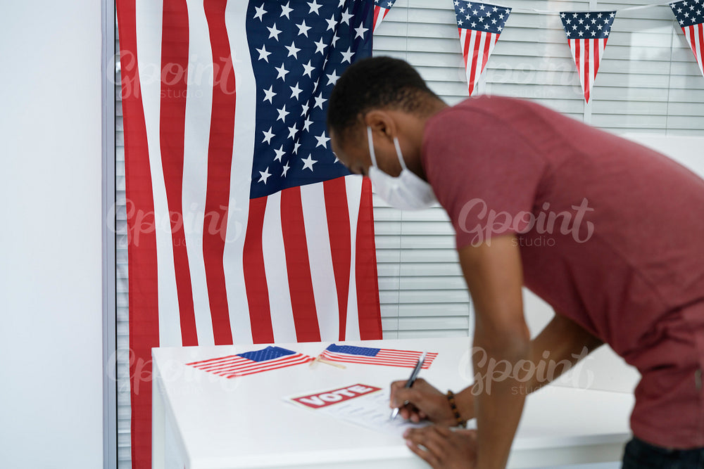 Man voting in face mask