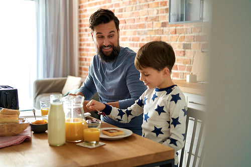 Happy father and son during breakfast at the morning