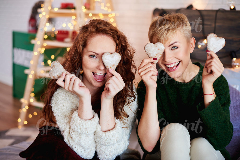 Portrait of playful girls with gingerbread cookies