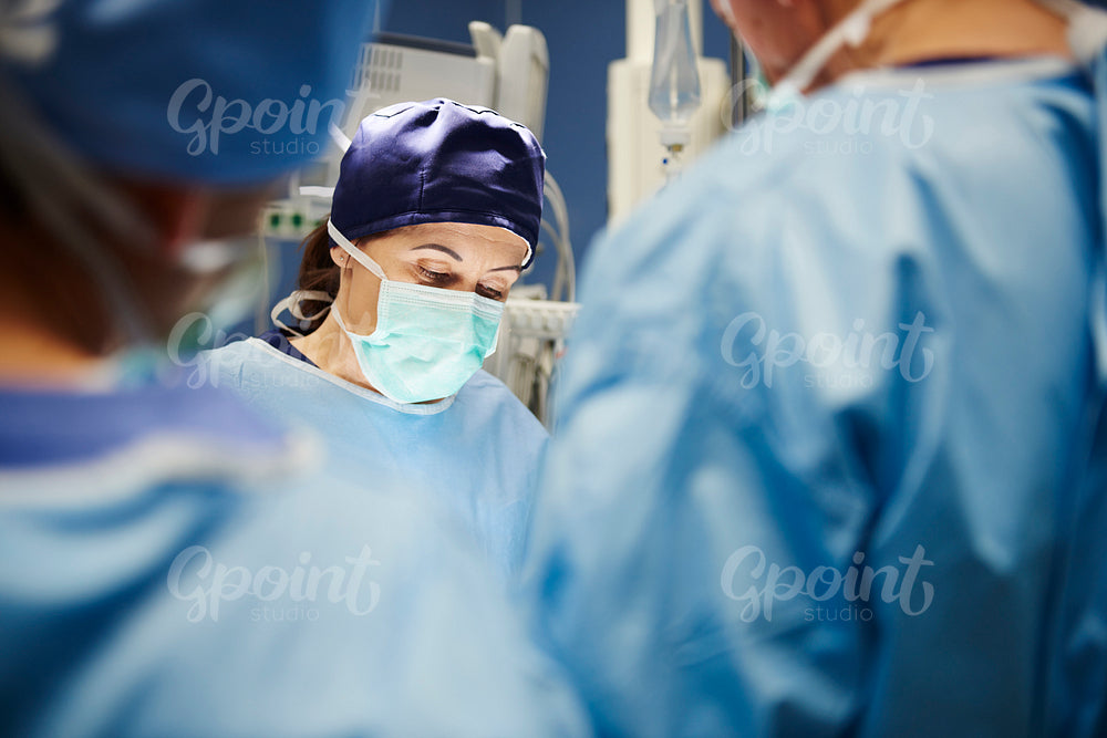 Mature female surgeon during an operation