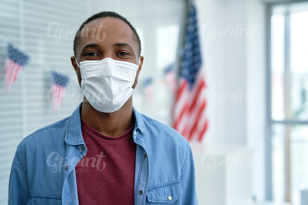 Black man in face mask in ballot place