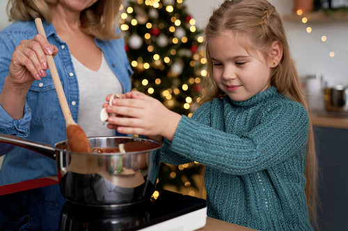 Little cute girl helping while preparing Christmas food