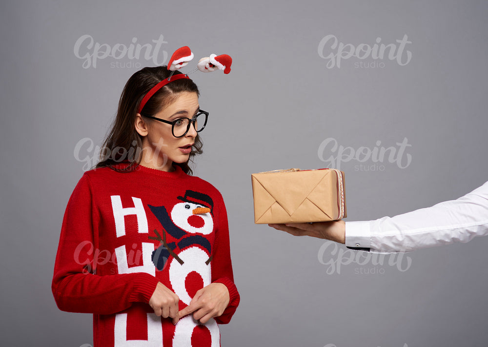 Woman with Christmas gift and funny face