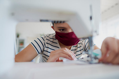 Close up of Asian woman sewing a pollution mask