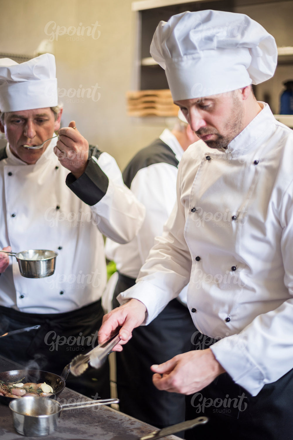 Three cooks preparing main course