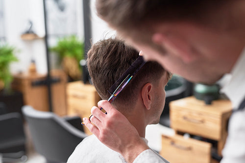Young man has cutting hair at the hairdresser