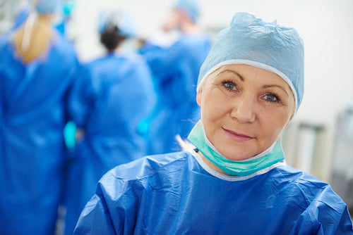 Mature female surgeon in surgical cap