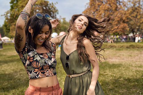 Young women dancing together at music festival