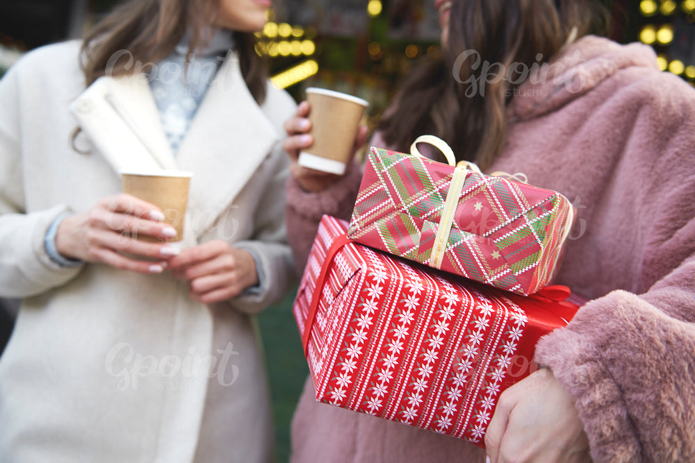 Two friends on Christmas Market carrying Christmas presents