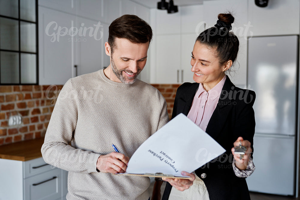 Man  signing contract of new apartment