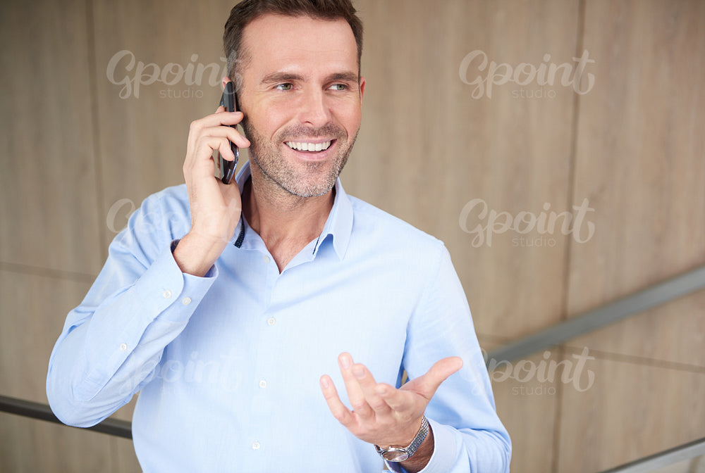 Businessman talking on the phone at work