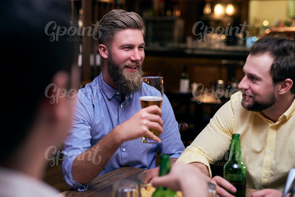 Male friends spending time together in the pub