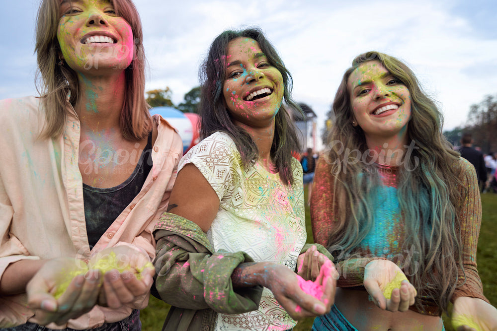 Group of friends looking at camera at Holi Festival  