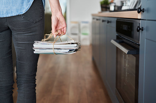 Woman about to throw away segregated paperwaste