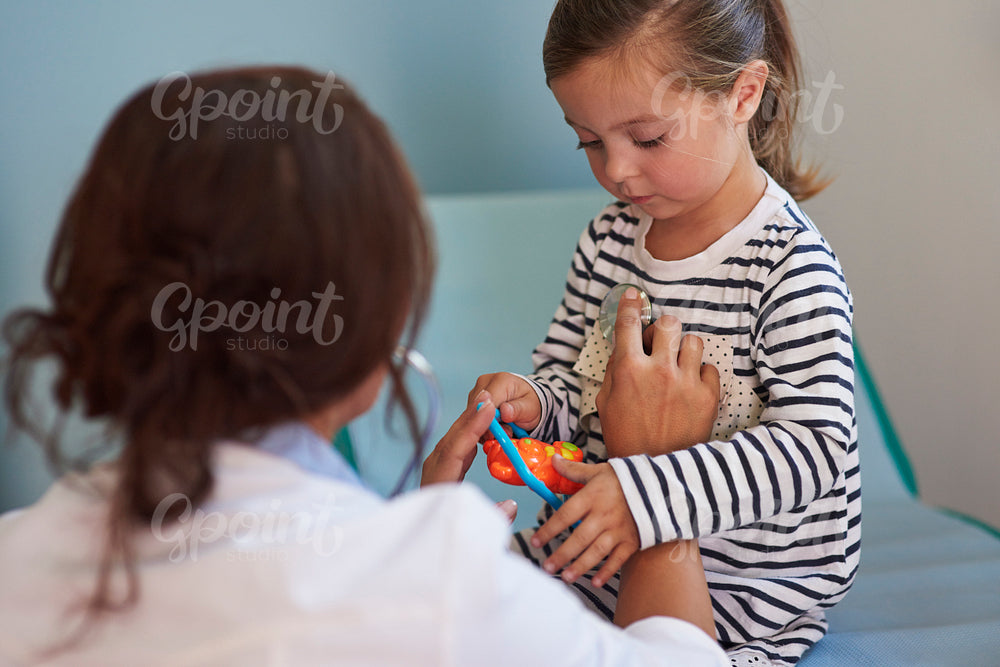 Doctor examining her very little patient