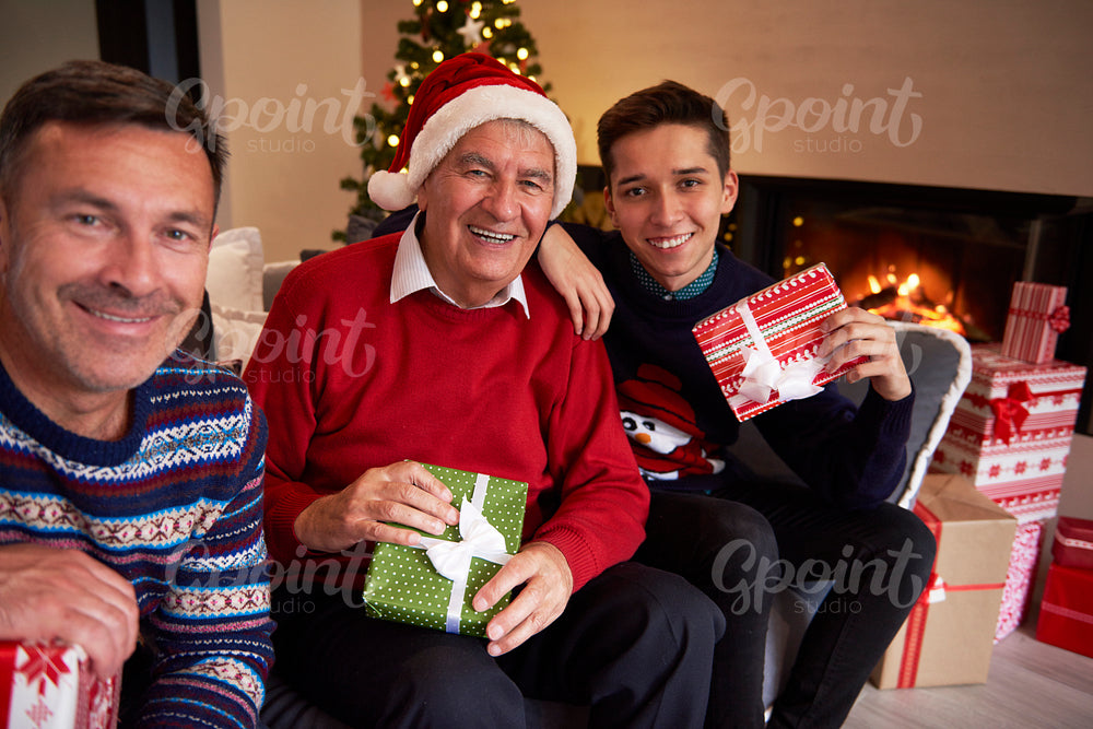 Three smiling men in the living room