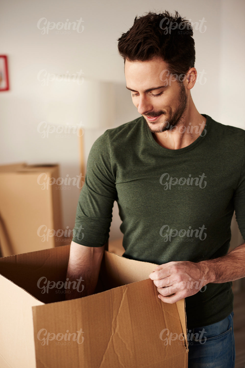 Man taking his stuff out from the cardboard box