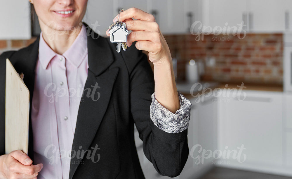 Close up of real estate agent with house key