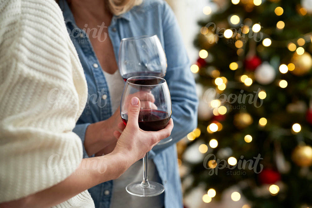 Close up of hands with glasses of wine during Christmas