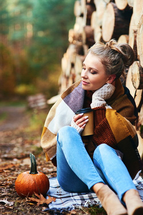 Beautiful young woman relaxing in the forest autumn