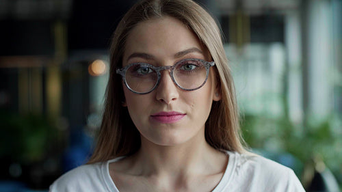 Portrait of smiling, young woman with glasses